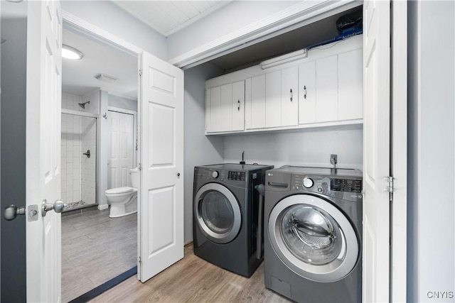 1019 State Route 49, Constantia, NY 13028 - washroom featuring cabinet space, independent washer and dryer, and light wood-style floors