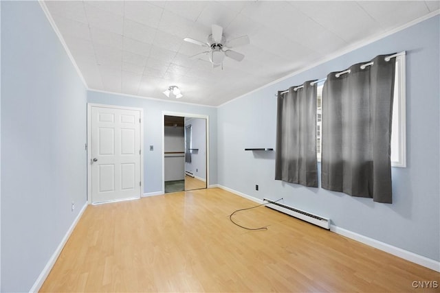 1019 State Route 49, Constantia, NY 13028 - empty room featuring a baseboard heating unit, crown molding, a ceiling fan, wood finished floors, and baseboards