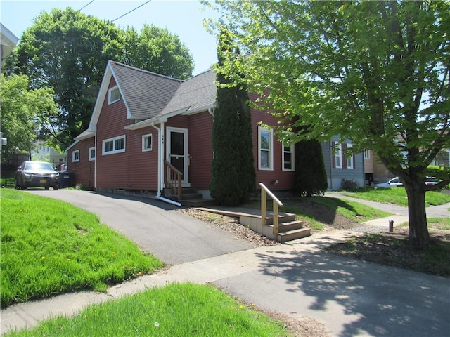 view of front of property with a shingled roof and entry steps