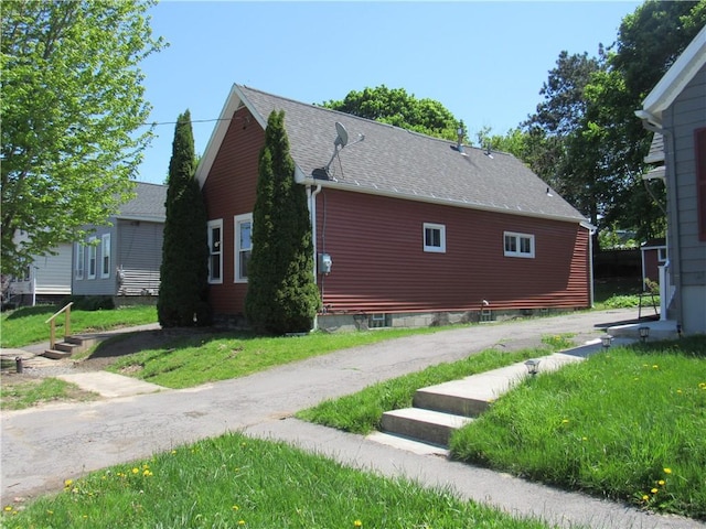 view of property exterior featuring a shingled roof
