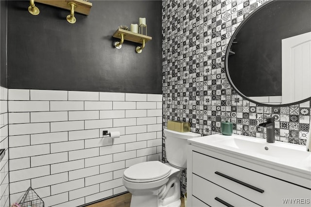 3750 Transit Rd, Orchard Park, NY 14127 - half bath featuring tile walls, toilet, vanity, and tasteful backsplash