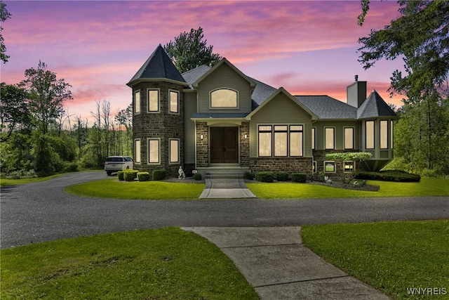 3750 Transit Rd, Orchard Park, NY 14127 - view of front of home featuring a lawn, a chimney, and stone siding