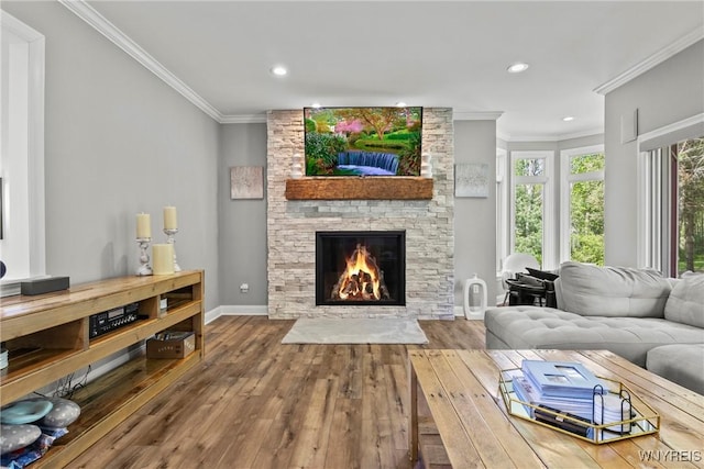 3750 Transit Rd, Orchard Park, NY 14127 - living room featuring hardwood / wood-style floors, crown molding, a stone fireplace, recessed lighting, and baseboards