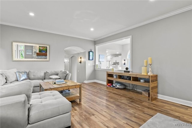 3750 Transit Rd, Orchard Park, NY 14127 - living room featuring arched walkways, ornamental molding, wood finished floors, baseboards, and recessed lighting