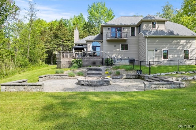 3750 Transit Rd, Orchard Park, NY 14127 - rear view of property featuring a fire pit, a patio, a wooden deck, and a chimney