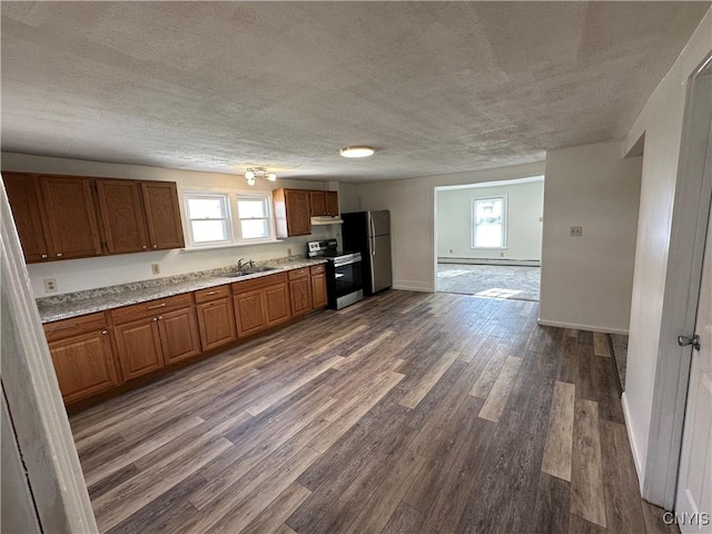24 W Main St, Eaton, NY 13408 - kitchen with appliances with stainless steel finishes, brown cabinets, a textured ceiling, dark wood finished floors, and plenty of natural light