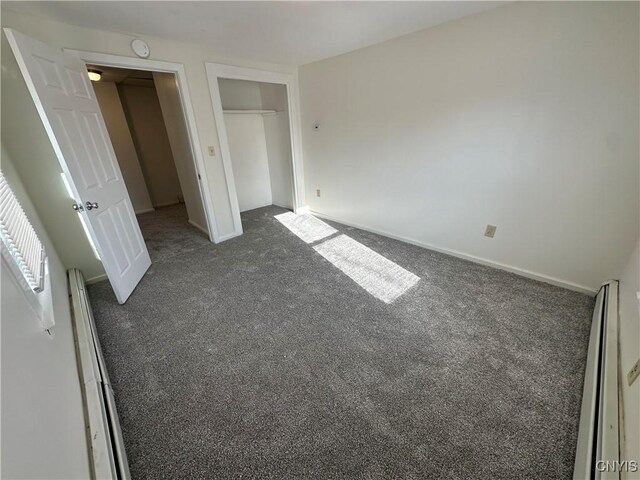 24 W Main St, Eaton, NY 13408 - unfurnished bedroom with carpet, baseboard heating, a closet, and baseboards