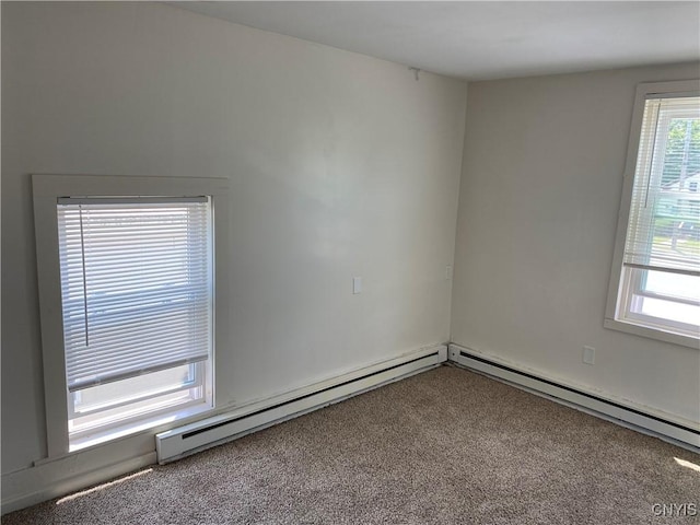 24 W Main St, Eaton, NY 13408 - carpeted empty room with a baseboard heating unit