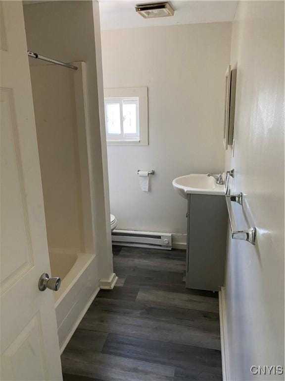 24 W Main St, Eaton, NY 13408 - full bathroom with baseboard heating, vanity, toilet, wood finished floors, and baseboards