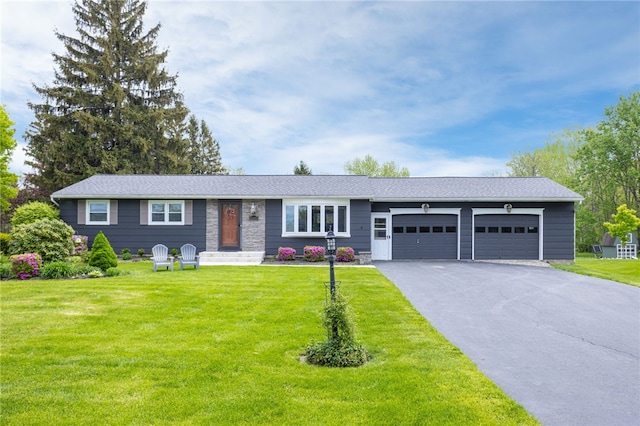 ranch-style home with an attached garage, asphalt driveway, and a front yard