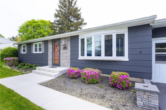 single story home featuring stone siding