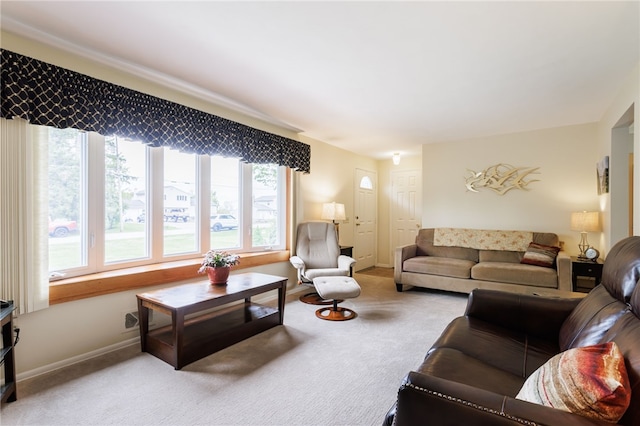 carpeted living room featuring baseboards