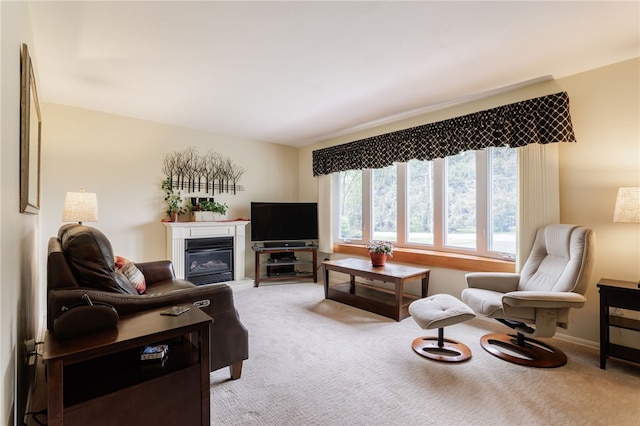 living area with light colored carpet and a glass covered fireplace