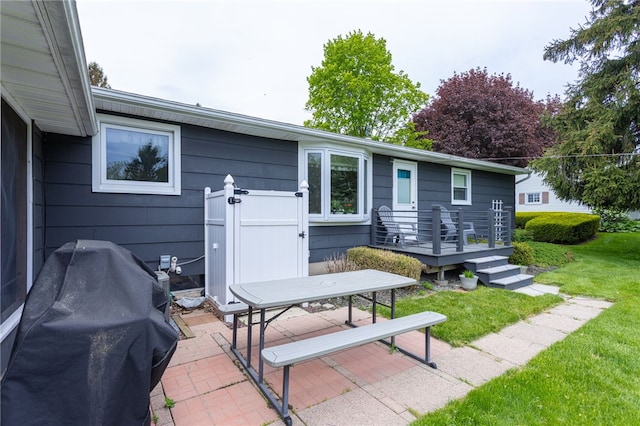 view of patio with a grill and a wooden deck