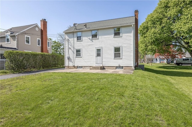 back of house featuring a chimney and a patio
