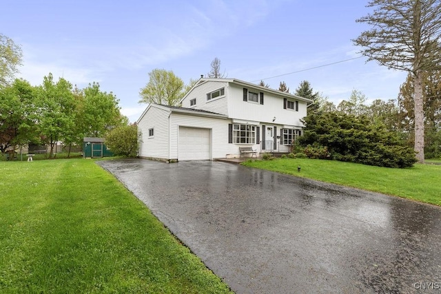 view of front of house featuring asphalt driveway, an attached garage, and a front lawn