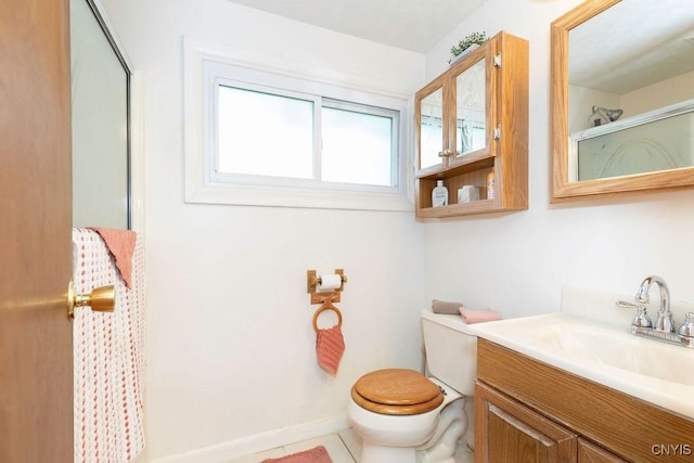 bathroom with a shower with shower door, toilet, and vanity