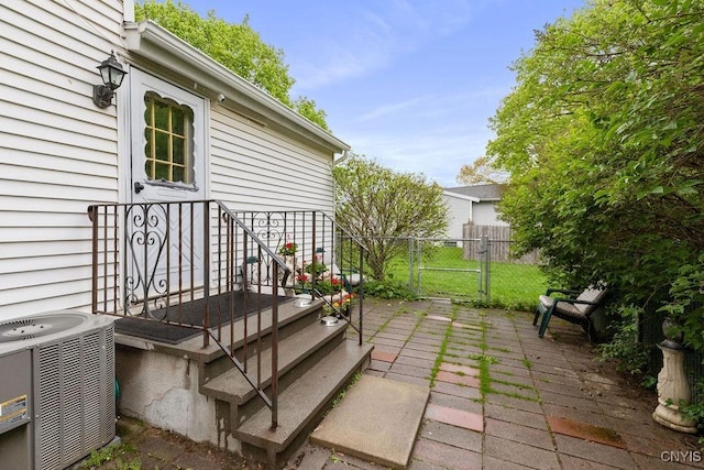 view of patio / terrace featuring central AC unit, fence, and a gate