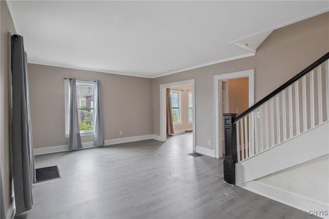 121 Roney Rd, Syracuse, NY 13205 - unfurnished living room with wood finished floors, baseboards, stairs, and attic access