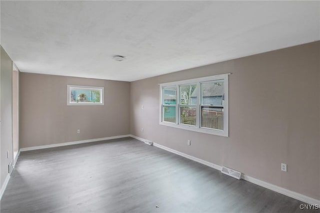 121 Roney Rd, Syracuse, NY 13205 - empty room featuring wood finished floors, plenty of natural light, and baseboards
