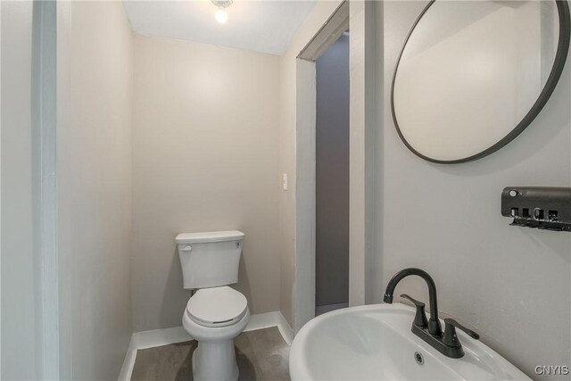 121 Roney Rd, Syracuse, NY 13205 - bathroom with toilet, baseboards, and a sink
