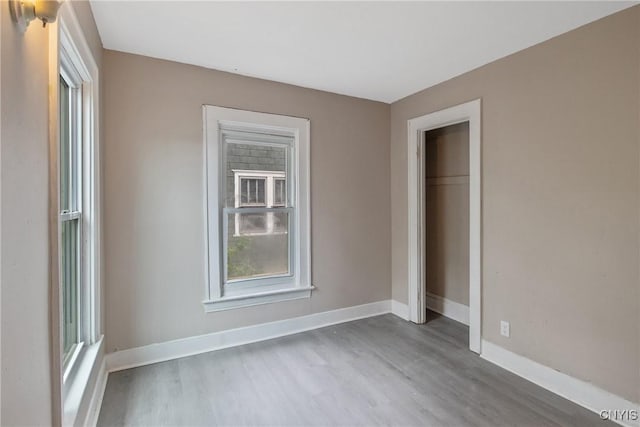 121 Roney Rd, Syracuse, NY 13205 - unfurnished bedroom featuring wood finished floors, baseboards, and a closet