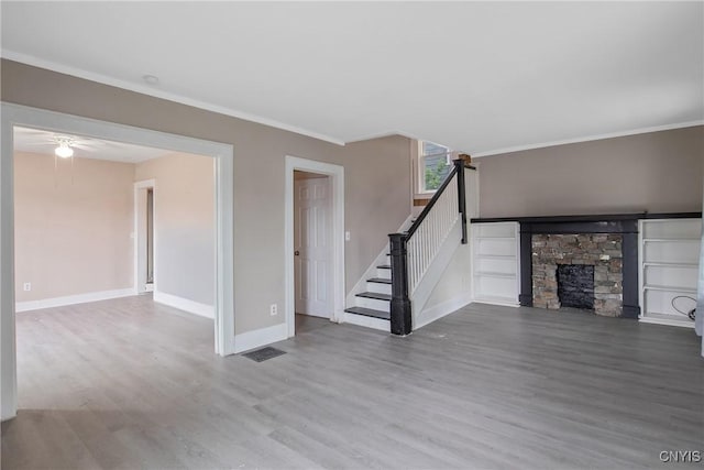 121 Roney Rd, Syracuse, NY 13205 - unfurnished living room with wood finished floors, ornamental molding, baseboards, stairway, and ceiling fan