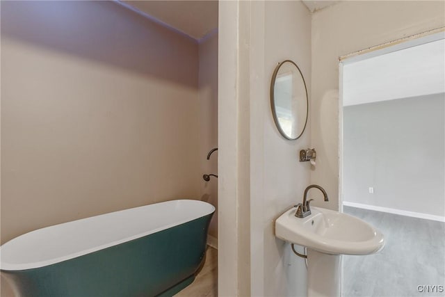 121 Roney Rd, Syracuse, NY 13205 - full bathroom with a soaking tub, wood finished floors, and baseboards