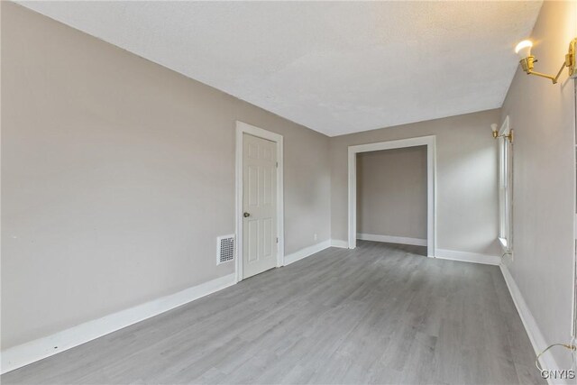 121 Roney Rd, Syracuse, NY 13205 - unfurnished room with wood finished floors and baseboards