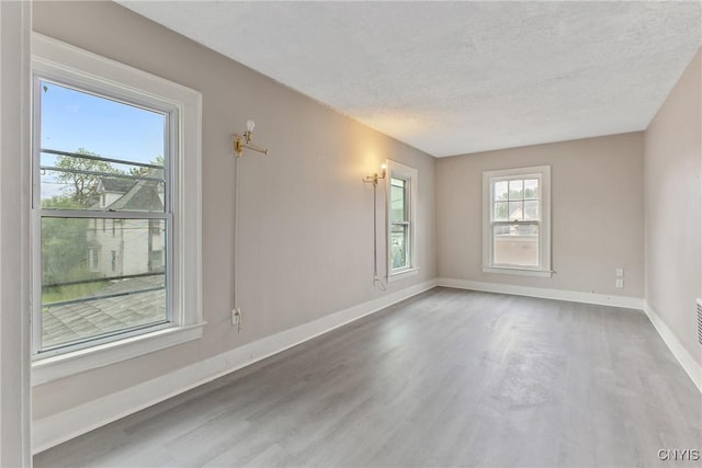 121 Roney Rd, Syracuse, NY 13205 - spare room featuring a textured ceiling, baseboards, and wood finished floors