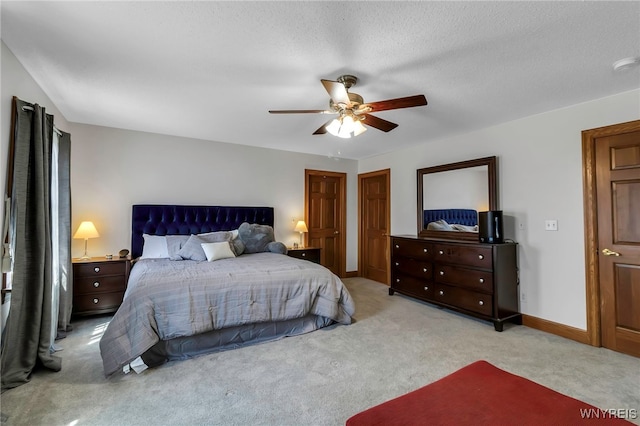 carpeted bedroom with a ceiling fan and baseboards