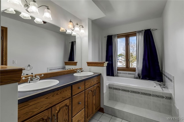 full bath with tile patterned floors, double vanity, and tiled tub