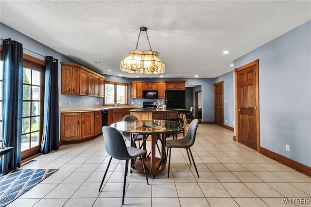 3472 Stevenson Ct, Wheatfield, NY 14120 - dining area featuring a chandelier, recessed lighting, light tile patterned floors, a textured ceiling, and baseboards