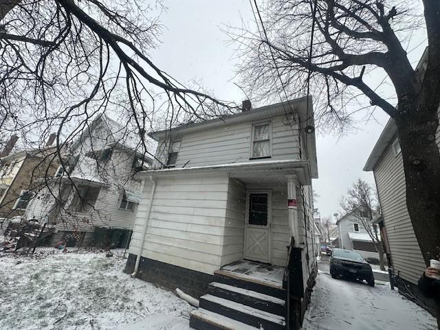 199 Roycroft Dr, Rochester, NY 14621 - snow covered back of property featuring a chimney