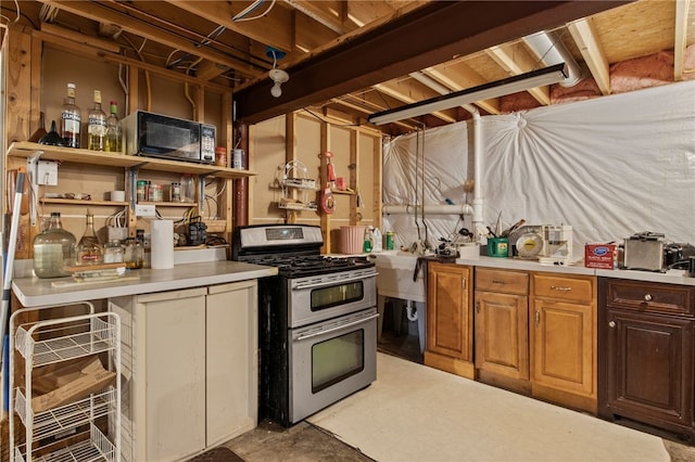kitchen with range with two ovens, black microwave, and light countertops