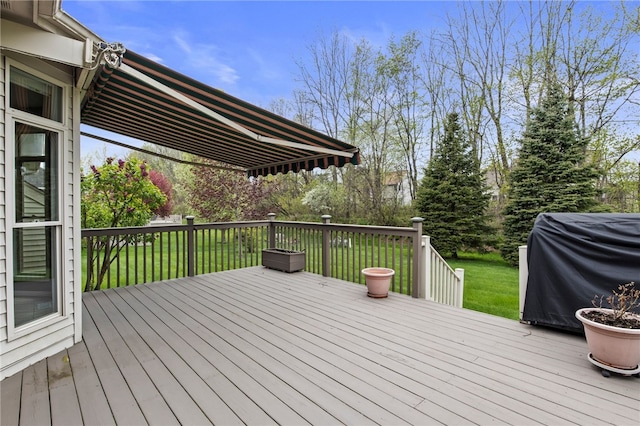 deck with grilling area and a yard