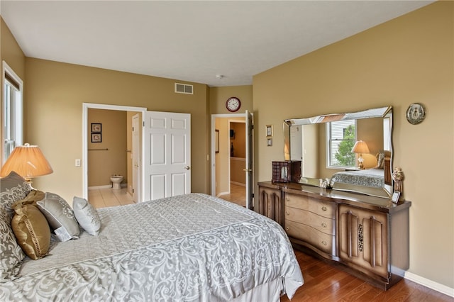 bedroom with baseboards and wood finished floors