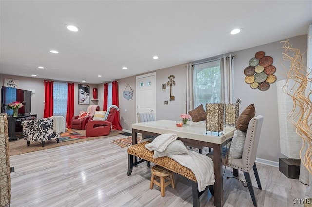 dining room featuring recessed lighting, baseboards, and light wood finished floors