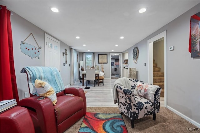 living room featuring recessed lighting, stairs, and baseboards