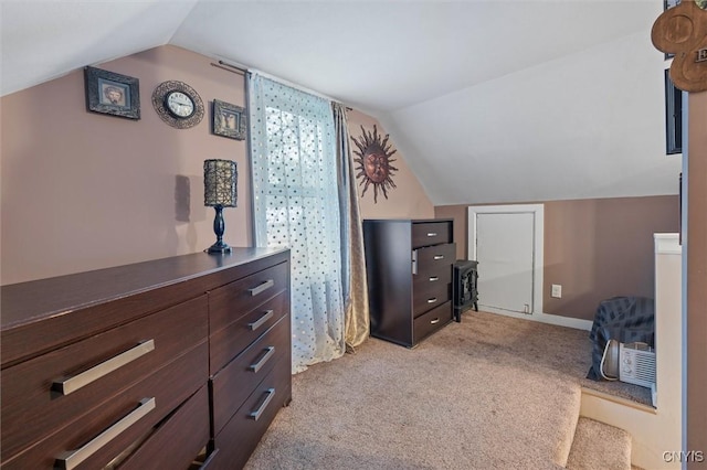 bedroom featuring lofted ceiling, light carpet, and baseboards