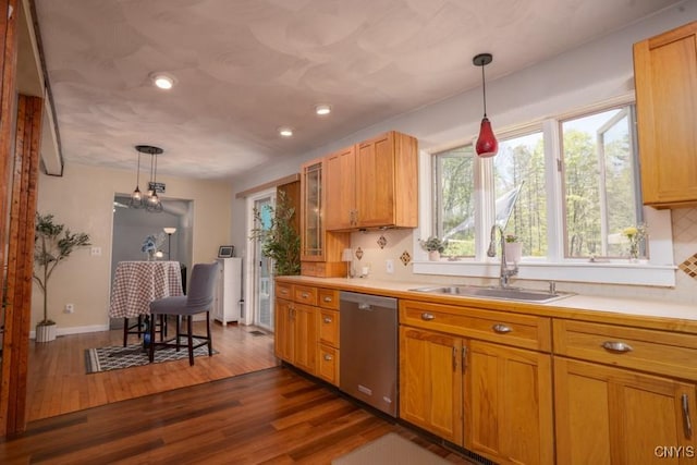 7735 Coates Rd N, Trenton, NY 13354 - kitchen with stainless steel dishwasher, a sink, backsplash, light countertops, and dark wood-type flooring