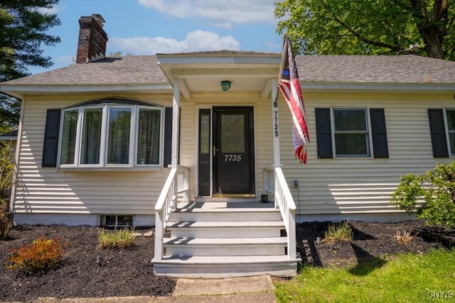 7735 Coates Rd N, Trenton, NY 13354 - view of front facade with a chimney and roof with shingles