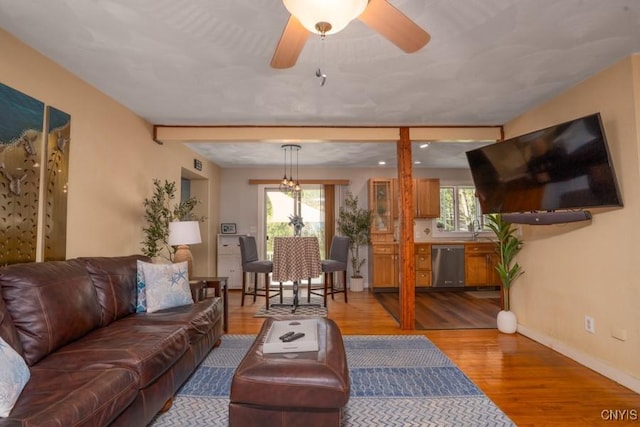 7735 Coates Rd N, Trenton, NY 13354 - living area featuring wood finished floors, baseboards, and ceiling fan