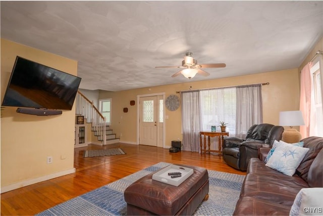 7735 Coates Rd N, Trenton, NY 13354 - living area featuring stairway, wood finished floors, a ceiling fan, and baseboards