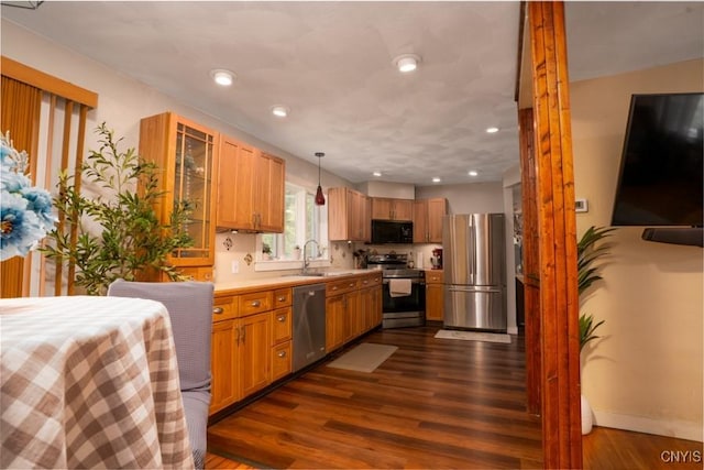 7735 Coates Rd N, Trenton, NY 13354 - kitchen with stainless steel appliances, light countertops, dark wood-type flooring, a sink, and recessed lighting