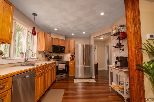 7735 Coates Rd N, Trenton, NY 13354 - kitchen with appliances with stainless steel finishes, a sink, light countertops, dark wood-type flooring, and pendant lighting