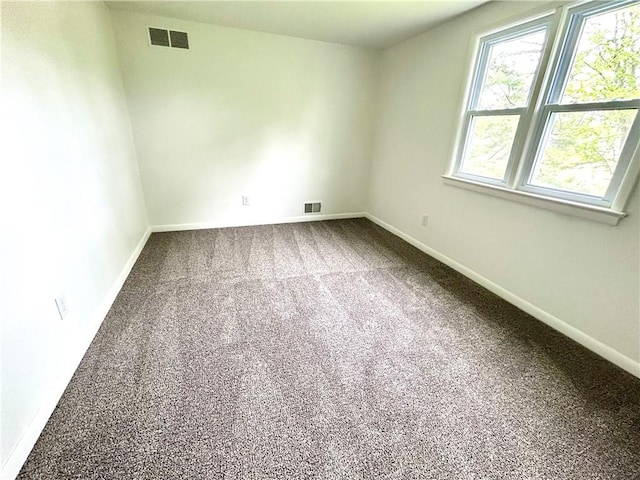 unfurnished room featuring carpet flooring and baseboards