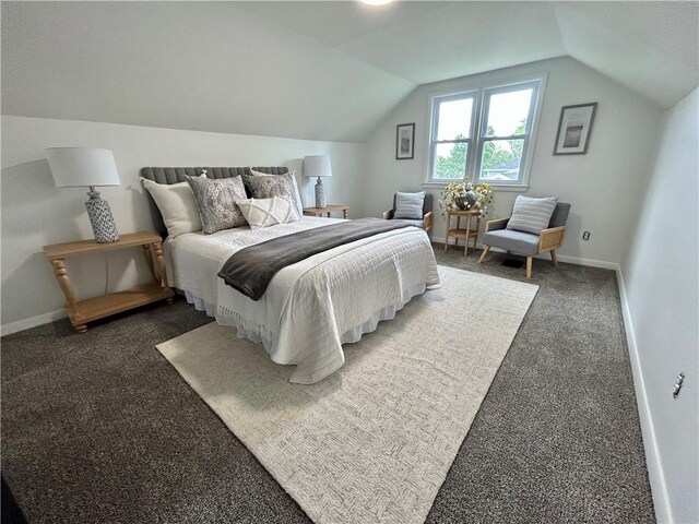 bedroom with lofted ceiling, carpet floors, and baseboards