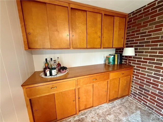 kitchen featuring brown cabinetry and dark countertops