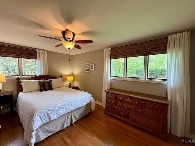 bedroom featuring wood finished floors, ceiling fan, and baseboards